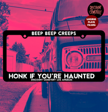 Load image into Gallery viewer, HONK IF YOU&#39;RE HAUNTED™ license plate frame